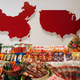 Products of WH Group are displayed in front of maps of China (L) and the United States at a news conference about the company’s IPO in Hong Kong in 2014.